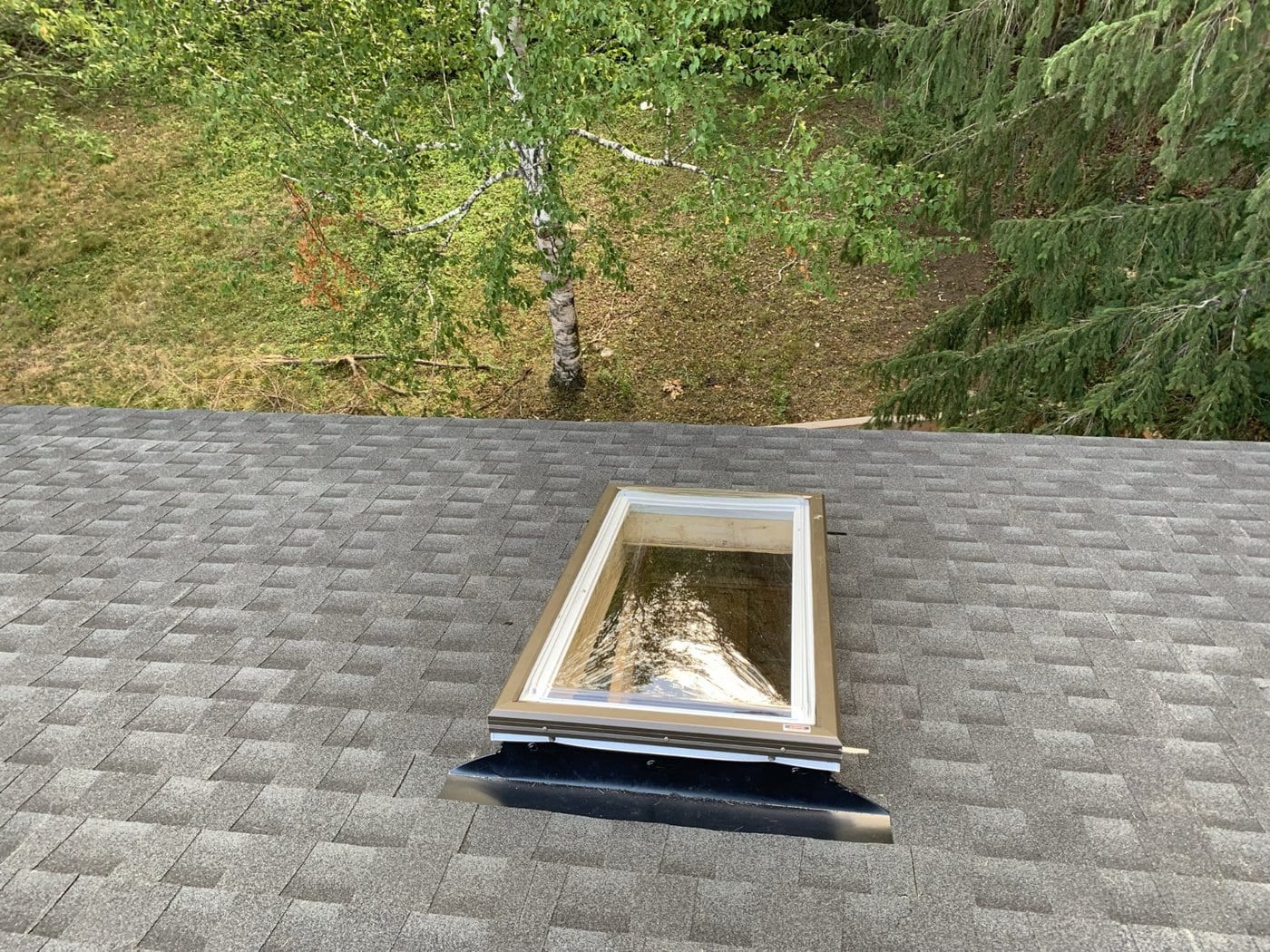 Skylight on an asphalt shingle roof, a common place for roof leaks to start